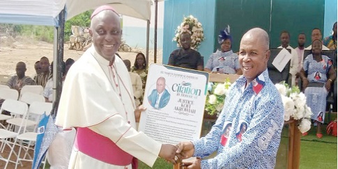 Most Rev. Joseph Afrifa Agyekum (left) presenting a citation to Justice Kofi Akrowiah at the ceremony
